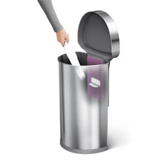 45L semi-round sensor bin - brushed finish - hand taking liner out of liner pocket